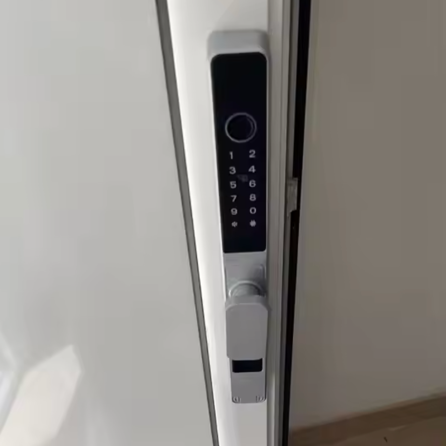 Silver short-handle smart door lock with the keypad and latch visible on a white door
