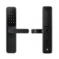 Black lever-handle smart door lock, outer keypad panel with fingerprint reader and inner panel